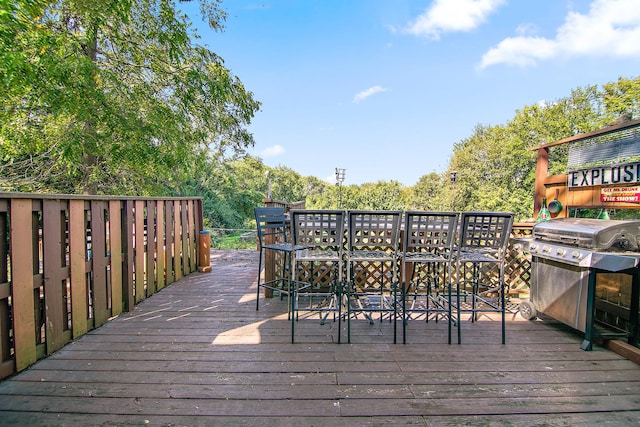 wooden terrace with a grill