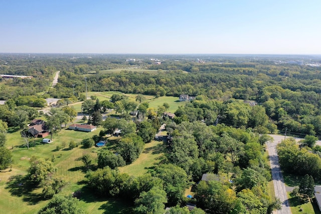 drone / aerial view featuring a wooded view