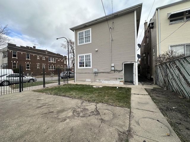 rear view of property with fence