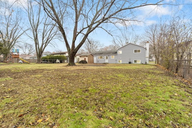 view of yard with a fenced backyard and a playground