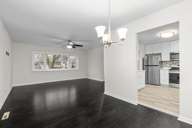 unfurnished living room featuring baseboards, light wood finished floors, and ceiling fan with notable chandelier