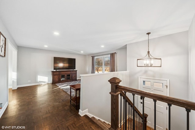 hall with baseboards, a chandelier, an upstairs landing, and recessed lighting