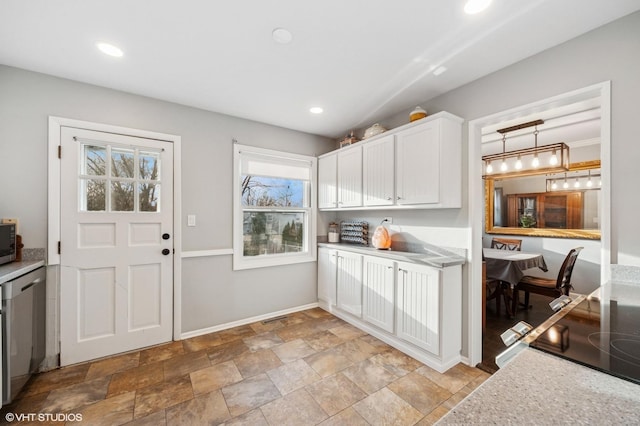 kitchen with recessed lighting, baseboards, white cabinets, light countertops, and appliances with stainless steel finishes