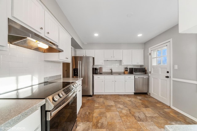 kitchen featuring decorative backsplash, appliances with stainless steel finishes, white cabinets, a sink, and under cabinet range hood