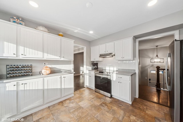 kitchen with under cabinet range hood, tasteful backsplash, appliances with stainless steel finishes, and white cabinets