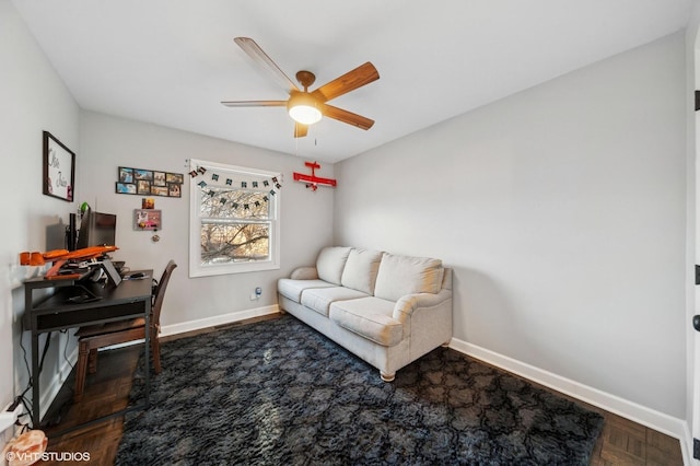 home office featuring baseboards and a ceiling fan