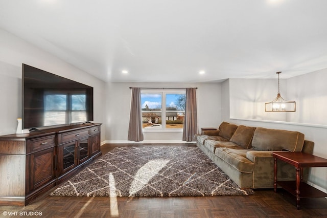 living area featuring recessed lighting, a notable chandelier, and baseboards