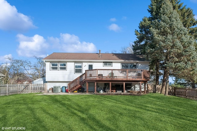 back of property featuring a deck, a yard, stairway, and a fenced backyard