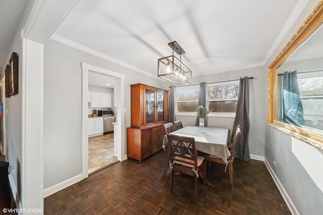 dining space featuring a notable chandelier, ornamental molding, and baseboards