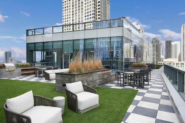 view of patio featuring a view of city, outdoor lounge area, and area for grilling