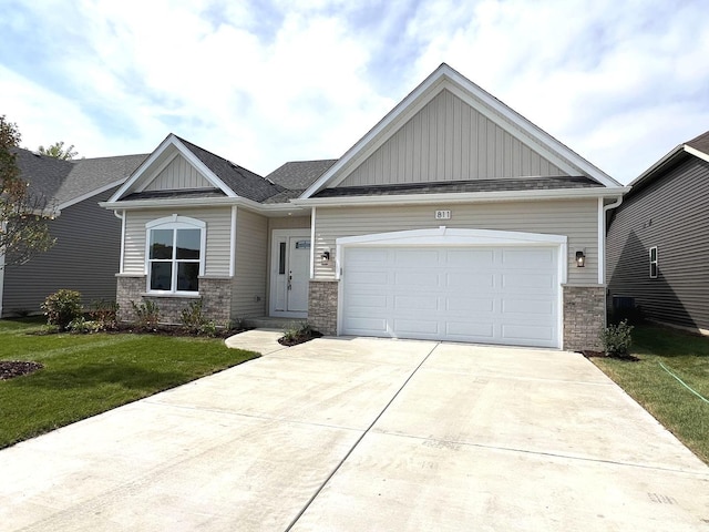 craftsman house with a garage, a front lawn, board and batten siding, and concrete driveway