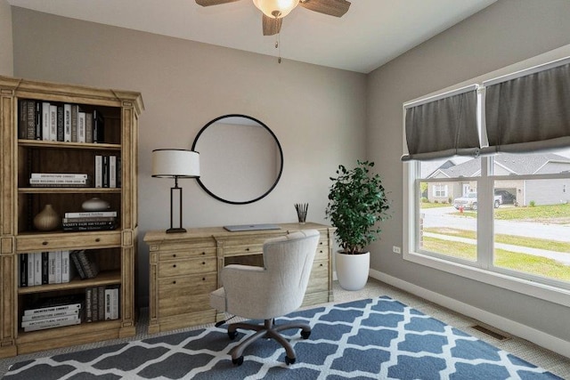 office area featuring baseboards, visible vents, and ceiling fan