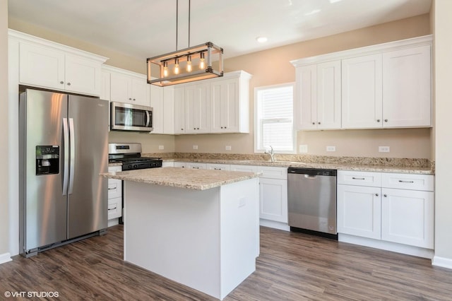 kitchen with dark wood-style floors, stainless steel appliances, a sink, and white cabinets