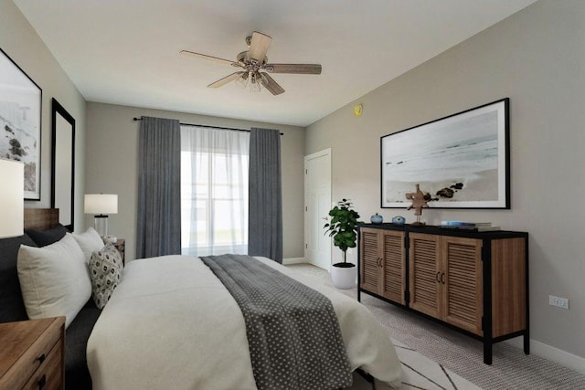 bedroom featuring light carpet, a ceiling fan, and baseboards