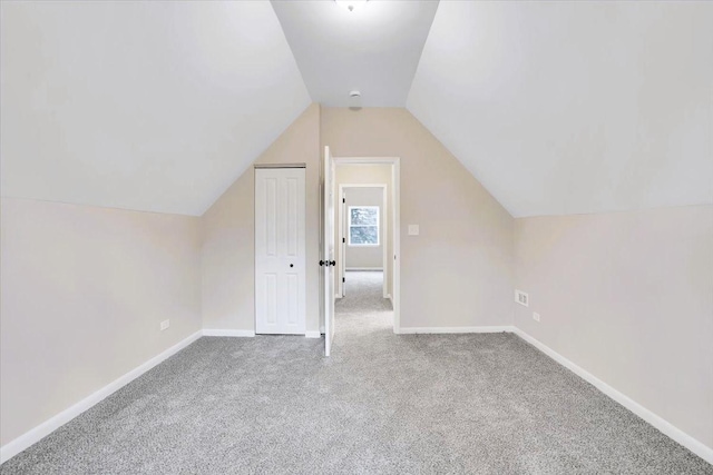 bonus room with carpet flooring, vaulted ceiling, and baseboards