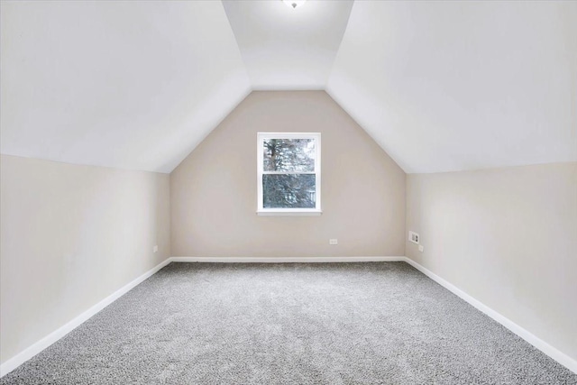 bonus room with lofted ceiling, carpet, and baseboards