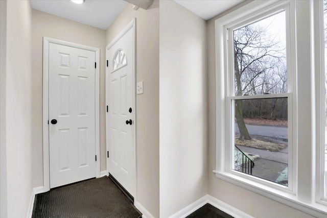 doorway featuring baseboards