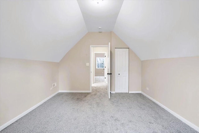 bonus room with lofted ceiling, carpet floors, and baseboards