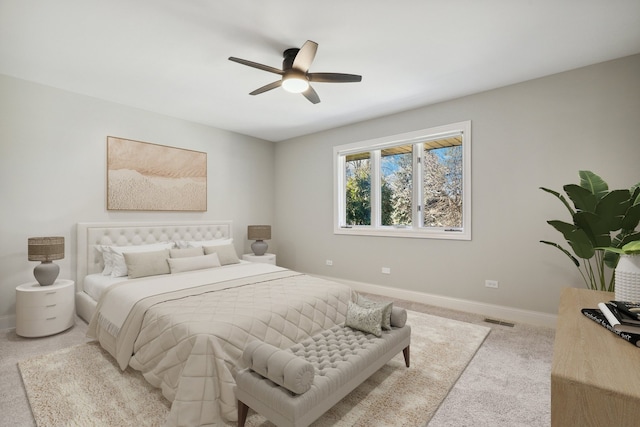 bedroom featuring visible vents, baseboards, light carpet, and ceiling fan