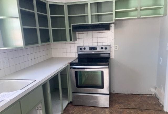 kitchen with under cabinet range hood, light countertops, backsplash, and stainless steel range with electric cooktop