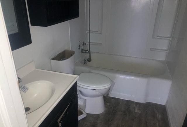 bathroom featuring toilet, shower / washtub combination, and vanity