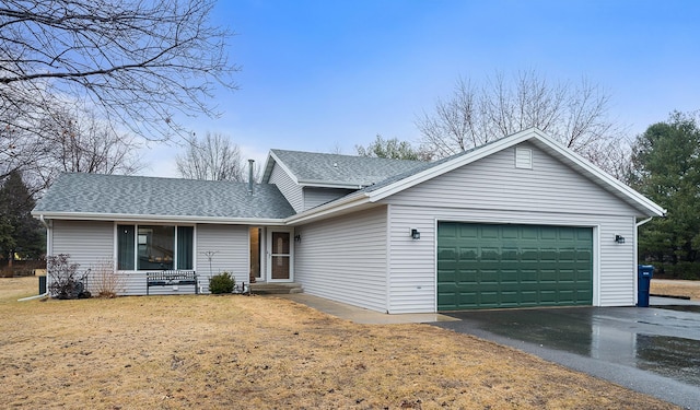 ranch-style house with a front yard, roof with shingles, driveway, and an attached garage