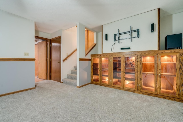 bar with carpet floors, stairs, and baseboards