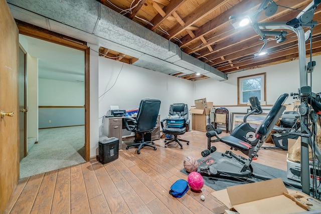 exercise room with wood-type flooring