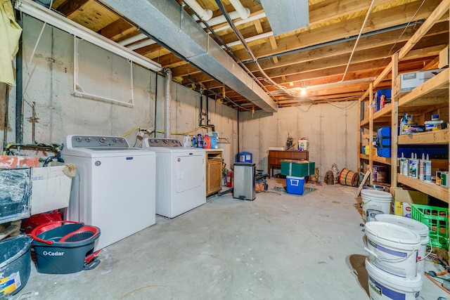 unfinished below grade area with a sink and washing machine and clothes dryer