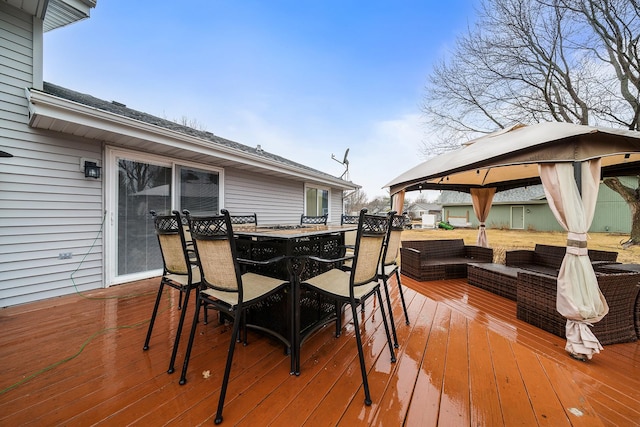 wooden deck featuring outdoor dining space, outdoor lounge area, and a gazebo