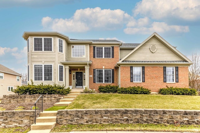 traditional-style home featuring brick siding and a front lawn