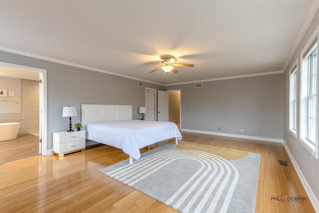 bedroom featuring baseboards, visible vents, light wood-type flooring, and crown molding