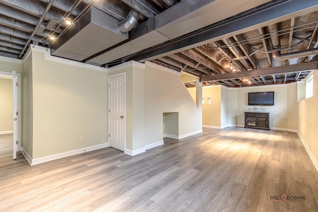 finished basement featuring baseboards and wood finished floors