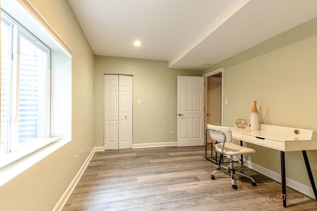 office with plenty of natural light, baseboards, and wood finished floors