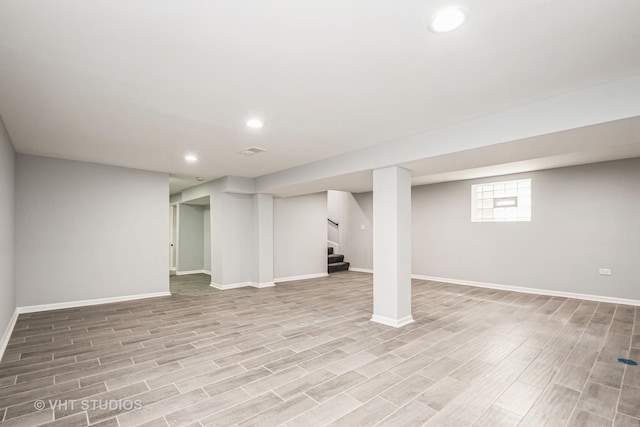 below grade area with stairs, recessed lighting, baseboards, and wood tiled floor