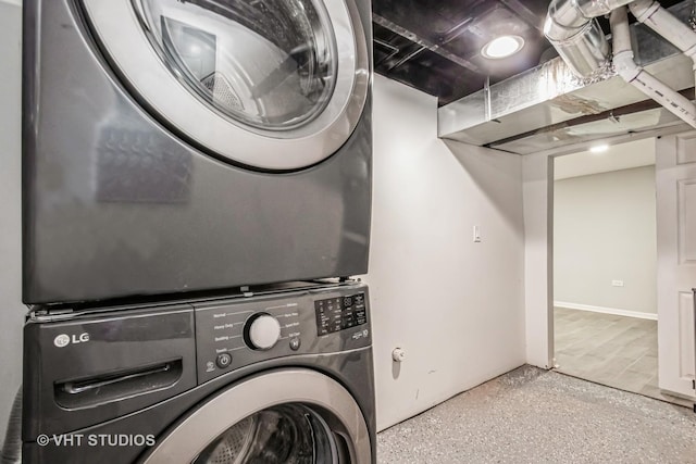 laundry area with stacked washer and clothes dryer and laundry area