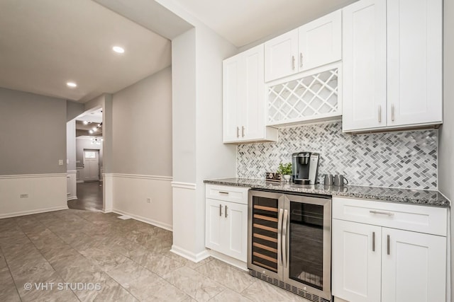 bar with a dry bar, beverage cooler, baseboards, decorative backsplash, and recessed lighting