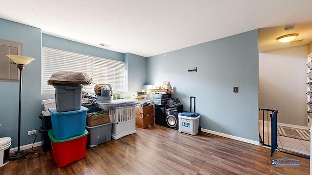 office area with visible vents, baseboards, and wood finished floors