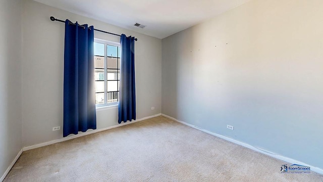 spare room with visible vents, baseboards, and carpet floors