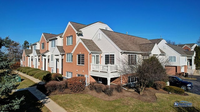 back of property featuring a residential view and a lawn