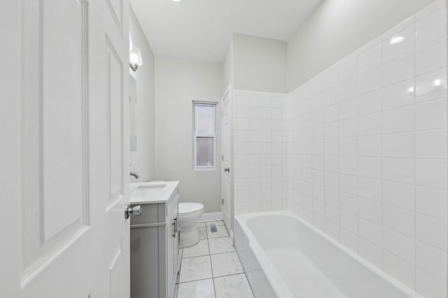 bathroom with baseboards, vanity, toilet, and tile patterned floors