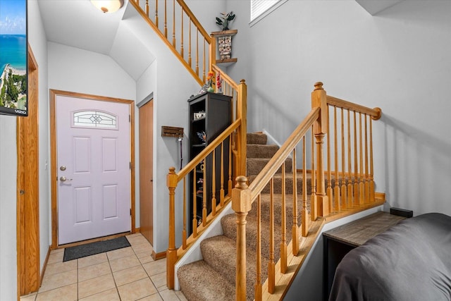 entryway with stairs, plenty of natural light, and tile patterned floors