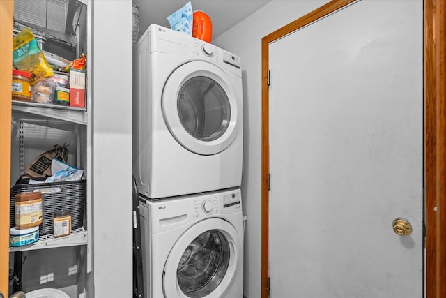 laundry room featuring stacked washing maching and dryer and laundry area