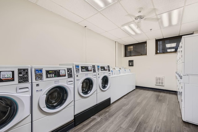 common laundry area featuring separate washer and dryer, stacked washer / dryer, wood finished floors, visible vents, and a ceiling fan