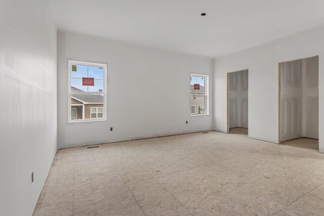 unfurnished room featuring baseboards, carpet, and a ceiling fan