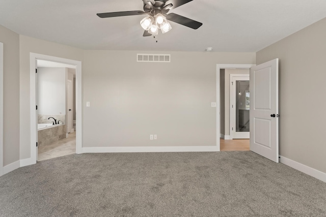 unfurnished bedroom with baseboards, visible vents, carpet floors, and ceiling fan