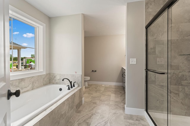 bathroom featuring vanity, baseboards, a shower stall, a garden tub, and toilet