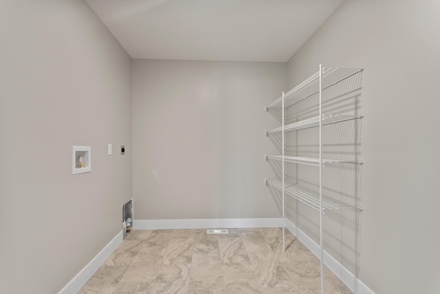 laundry area featuring washer hookup, laundry area, baseboards, and marble finish floor