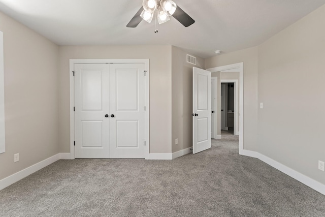 unfurnished bedroom with visible vents, carpet floors, baseboards, and a closet