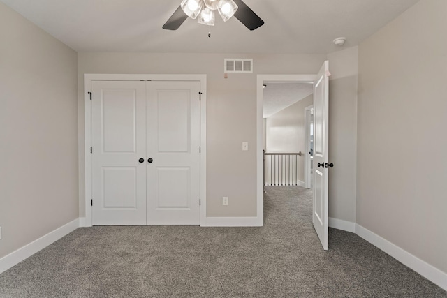 unfurnished bedroom featuring carpet, visible vents, and baseboards